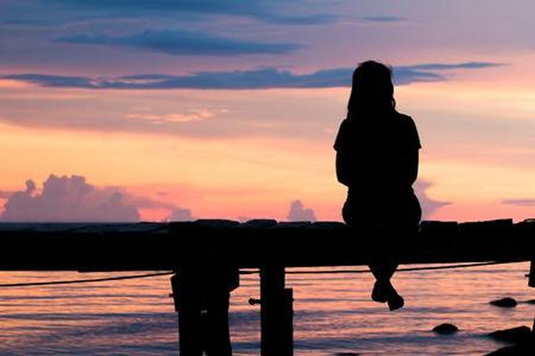 49160349 lonely woman sitting on a wooden bridge sunset style abstract shadows silhouette